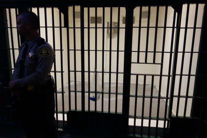                                A Los Angeles County Sheriff's Deputy stands in front of an empty cell at Men's Central Jail.