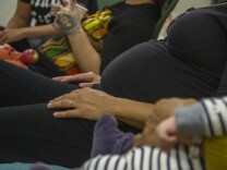 Pregnant women sit in a row at Kindred Space 