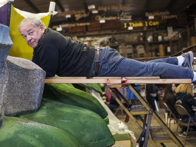 Volunteer Ken Tyminski of North Carolina decorates umbrellas with nigella seeds at Sierra Madre Rose Float Association's barn on Tuesday morning, Dec. 29, 2015. Tyminski and his wife have been volunteering on the float for the past three years. They first started working on this year's float on Christmas day.