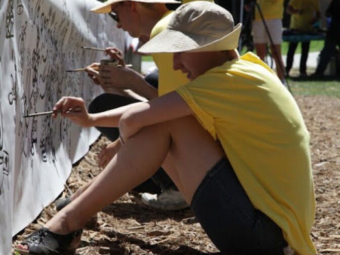 Heart of Los Angeles Volunteers writing on the front stage of the Levitt Pavilion 