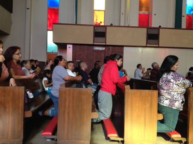 Latino parishioners at Our Lady of the Holy Rosary Church in Sun Valley listen to a mass centered around the topic of comprehensive immigration reform.