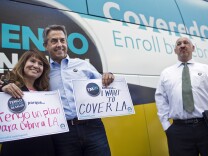 Covered California Executive Director Peter Lee takes photos with attendees during a press conference on Friday, Nov. 15, 2014 at Grand Park kicking off Covered California's second open enrollment period. The event was part of a statewide bus tour that stopped in more than 20 cities to raise awareness about enrollment.