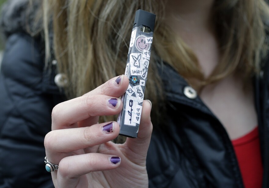 A 15-year-old in Cambridge, Mass., shows off her vaping device in 2018. Schools and health officials across the U.S. are struggling to curb what they say is an epidemic of underage vaping.