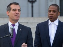 Mayor Eric Garcetti, left, and Shawn "Jay-Z" Carter announce the Made in America Festival from the steps of City Hall on April 16, 2014, in Los Angeles.
