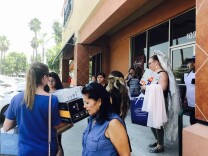 Alfred Angelo employees leave the store Friday morning, July 14, 2017, as crowds ask for help finding their bridal gowns.