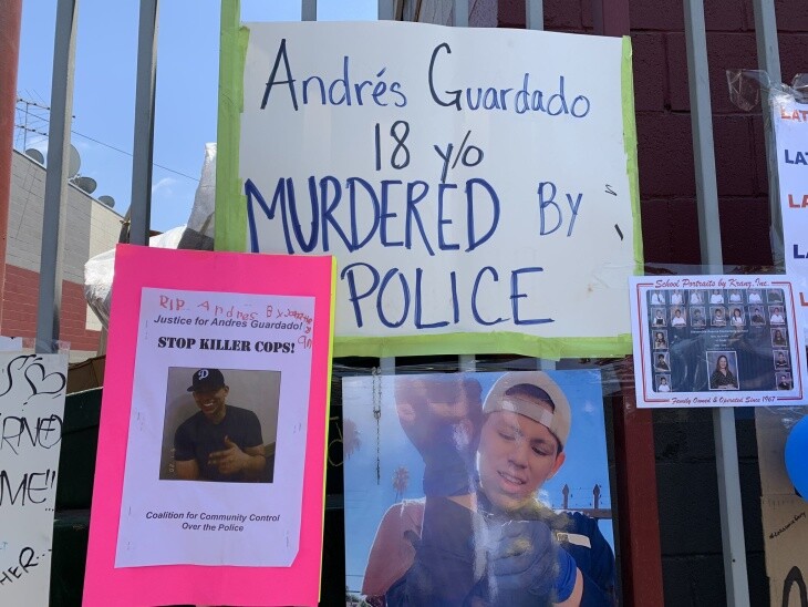 Handmade sign reads: Andrés Guardado 18 y/o murdered by police near photos of a young Latino.