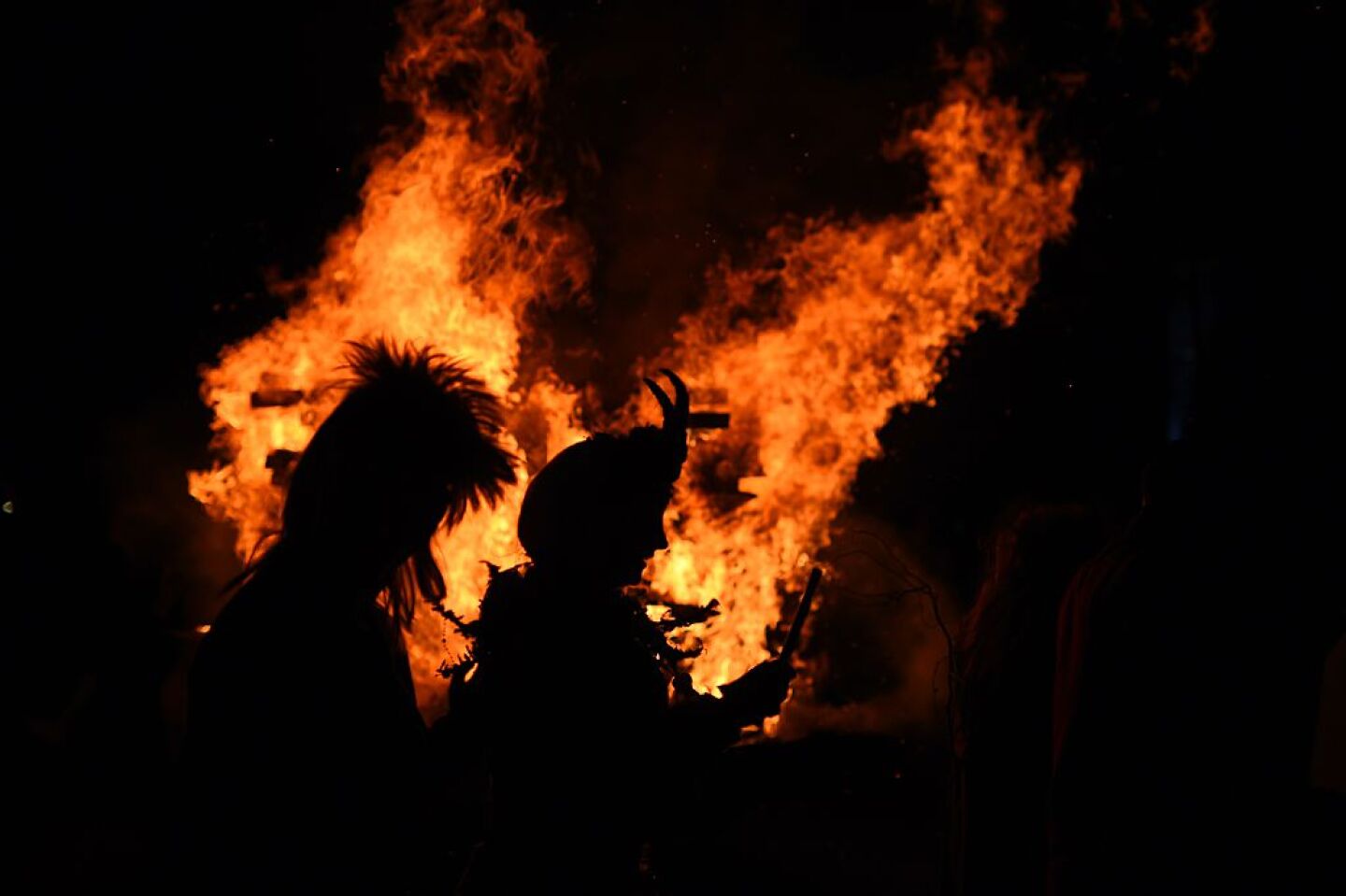 revelers dancing around a fire for Walpurgis Night (Walpurgisnacht)
