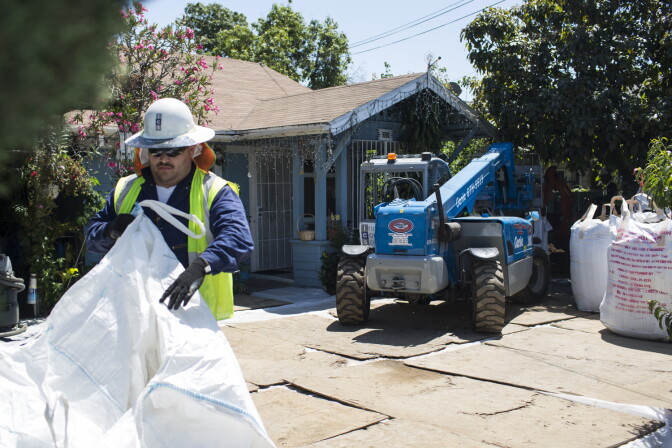 A soil removal, part of the Exide cleanup through the California Department of Toxic Substances Control, takes place at an East Los Angeles home on Wednesday, April 20, 2016.