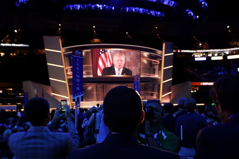 CLEVELAND, OH - JULY 19: Republican presidential candidate Donald Trump is seen speaking on a screen from New York City, on the second day of the Republican National Convention on July 19, 2016 at the Quicken Loans Arena in Cleveland, Ohio. Republican presidential candidate Donald Trump received the number of votes needed to secure the party's nomination. An estimated 50,000 people are expected in Cleveland, including hundreds of protesters and members of the media. The four-day Republican National Convention kicked off on July 18.  (Photo by Chip Somodevilla/Getty Images)