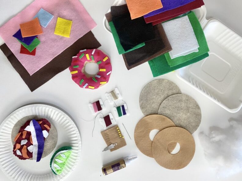 an overhead shot of pieces of brightly colored felt laid out on a white table
