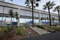 Southwest Airlines planes are parked on a tarmac outside a passenger terminal