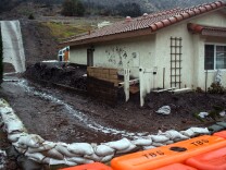 Sandbags lead water and debris flow to the street on San Como Lane in Camarillo Springs on Tuesday afternoon, Dec. 2, 2014. Authorities ordered a mandatory evacuation of the area earlier this morning. 