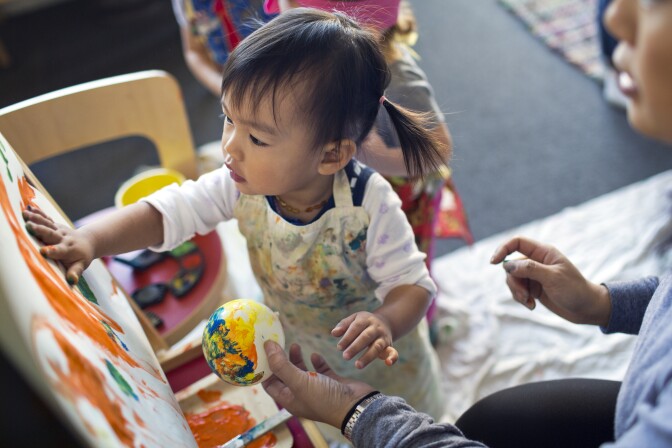 Twenty-two-month-old Maya Luu Guayasamin takes part in an art class in Long Beach on Thursday morning, Nov. 12, 2015 at The Family Nest, which provides bilingual early childhood education classes.