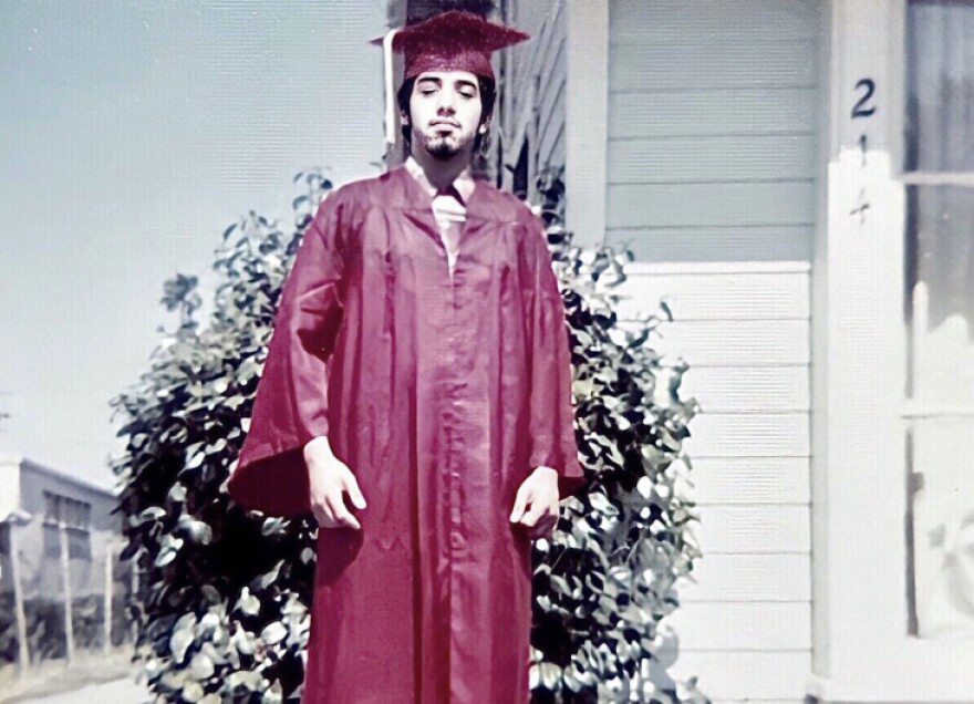Esther Lira's brother Charlie photographed in his gown upon his high school graduation.