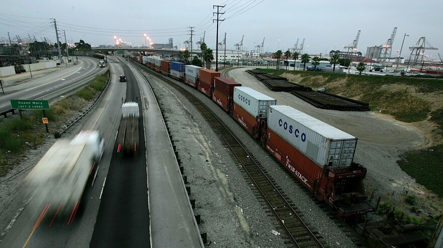Trucks move along the I-710 freeway in the predawn hours of Thursday, July 7, 2005, into the Port of Long Beach, Calif.