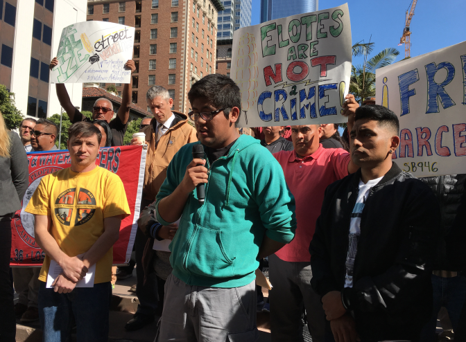 Roberto Rosas Rios, center, speaks at a rally in downtown Los Angeles on Thursday in support of his mother, street vendor Marcelina Rios. The elder Rios was arrested in October in San Bernardino County for illegally doing business as a street vendor. She received a misdemeanor citation and was taken into custody by local authorities, then was picked up by immigration agents. She now faces deportation.