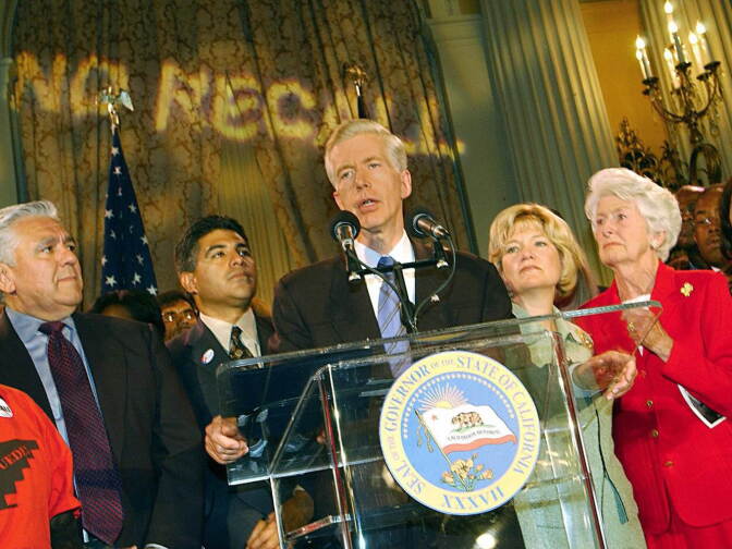 Supporters look on as California Governor Gray Davis (C) concedes the recall election to challenger Arnold Schwarzenegger at the Biltmore Hotel in Los Angeles on October 7, 2003
.
