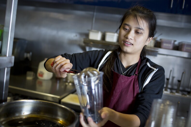 Giang Do, a drink maker and manager at Tebo Tebo Tea Lounge, pours warm boba into a cup while preparing a slush drink on Thursday, April 23, 2015 in Little Saigon.