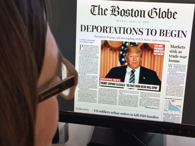 TOPSHOT - This April 10, 2016 photo taken in Washington shows a woman reading an online version of a mockup of what a frontpage might look like should Republican frontrunner Donald Trump win the presidency, as it condemned his "deeply disturbing" and "profoundly un-American" vision.
"Deportations to begin, President Trump calls for tripling of ICE (immigration and customs enforcement); riots continue," read The Boston Globe's fake headline, dated April 9, 2017.
It was posted on the editorial page, accompanied by a ruthless editorial article saying Trump's campaign "demands an active and engaged opposition."
 / AFP / Karen BLEIER        (Photo credit should read KAREN BLEIER/AFP/Getty Images)