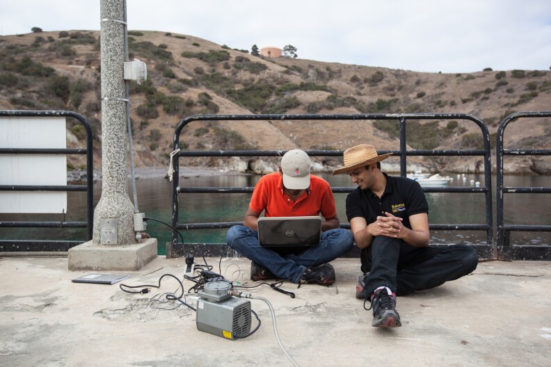 Supreeth Subbaraya (left) and Arvind Pereira are researchers at USC. They establish an initial link with the underwater robot.