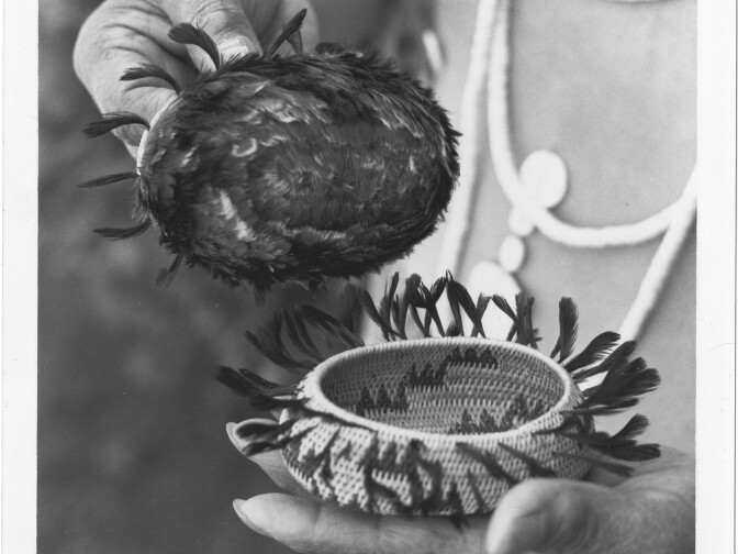 Photograph of Mabel McKay holding two of her baskets.