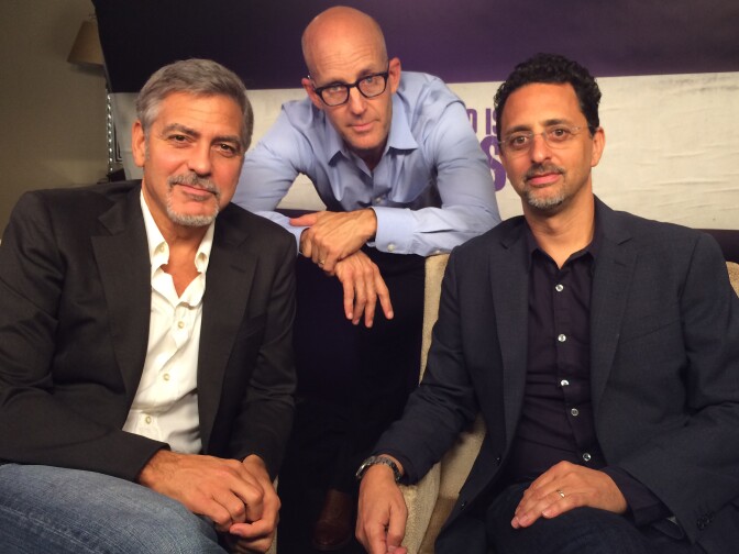 "Our Brand Is Crisis" producers George Clooney and Grant Heslov pose for a photo with The Frame host John Horn (center).