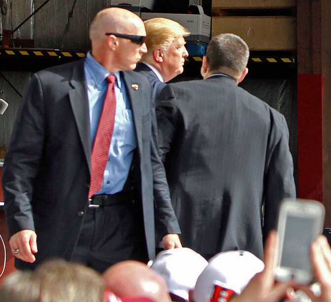 U.S. Secret Service agents guard Republican presidential candidate, businessman Donald Trump, on the stage after a man tried to breach the security buffer at his campaign event at the Wright Brothers Aero Hangar on March 12, 2016, in Vandalia, Ohio.
