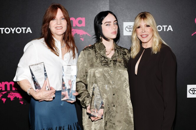 Billie Eilish at the 32nd Environmental Media Association (EMA) Awards Gala in Los Angeles, Oct. 8 2022. The pop star is flanked by her mother Maggie Baird (left) and EMA CEO Debbie Levin.