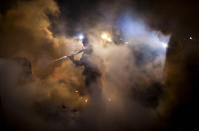 Firefirefighters work to contain and mop-up a fire during a massive fire in a residential neighborhood September 9, 2010 in a San Bruno, California. 
