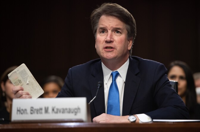 Judge Brett Kavanaugh holds up a copy of the US Constitution as he testifies during the second day of his US Senate Judiciary Committee confirmation hearing to be an Associate Justice on the US Supreme Court, on Capitol Hill in Washington, DC, September 5, 2018. - President Donald Trump's newest Supreme Court nominee Brett Kavanaugh is expected to face punishing questioning from Democrats this week over his endorsement of presidential immunity and his opposition to abortion. (Photo by SAUL LOEB / AFP)        (Photo credit should read SAUL LOEB/AFP/Getty Images)