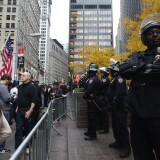 NEW YORK, NY - NOVEMBER 15:  Occupy Wall Street protesters and police stand outside Zuccotti Park after police removed the protesters from the park early in the morning on November 15, 2011 in New York City. Hundreds of protesters, who rallied against inequality in America, have slept in tents and under tarps since September 17 in Zuccotti Park, which has since become the epicenter of the global Occupy movement. The raid in New York City follows recent similar moves in Oakland, California, and Portland, Oregon.  (Photo by Mario Tama/Getty Images)