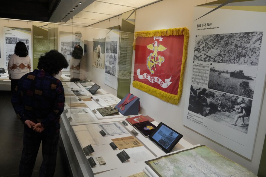 Visitors look at an exhibition of South Korean soldiers' records from the Vietnam War at the War Memorial of Korea in Seoul, Feb. 17.