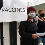 People arrive at a mobile Covid-19 vaccine site in Wilmington district of Los Angeles, California on April 13, 2021, where the Johnson & Johnson Covid-19 vaccine was due to be administered but changed to the Pfizer vaccine following a recommendation from federal health officials. - The US is calling for a pause on April 13, 2021 on administering the Johnson & Johnson Covid-19 vaccine due  to blood clotting concerns. (Photo by Frederic J. BROWN / AFP) (Photo by FREDERIC J. BROWN/AFP via Getty Images)