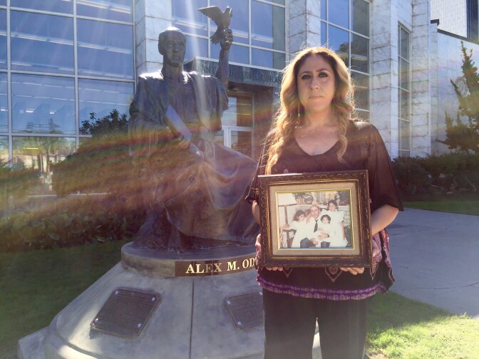 Helena Odeh, 37, the eldest daughter of Arab-American activist Alex Odeh stands near her father's statue at the Santa Ana Public Library. A pipe-bomb planted at the American-Arab Anti-Discrimination Committee office in Santa Ana killed Odeh in 1985 but no arrests or charges have ever been filed. 