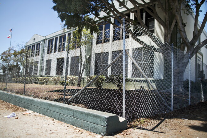 A newly installed chain-link fence surrounds lead-contaminated soil at Lorena Elementary School in Boyle Heights on Tuesday, Aug. 16, 2016.