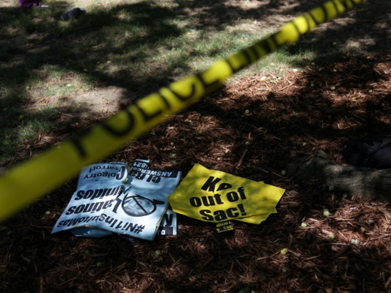 Police tape and protest signs at the state Capitol on Sunday, June 26, 2016, after violent clashes broke out between demonstrators and counter-protestors during a right-wing extremist rally.