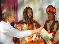 Hindu priest Shukavak Dasa (left) officiates at the wedding of Stephanie Young (center) and Neil Bajpayee in Pasadena, Calif., on May 4, 2013. 