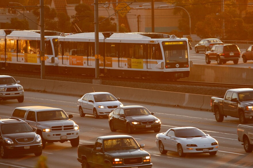 PASADENA, CA - DECEMBER 1:  Morning commuters travel by car and train along the 210 freeway between Los Angeles and cities to the east on December 1, 2009 near Pasadena, California. President Barack Obama will attend the international climate negotiations in Copenhagen next week with a vow to reduce US greenhouse gas emissions to about 17 percent below 2005 levels by 2020, and 83 percent by 2050. Meanwhile, California, which has some of the toughest clean air laws after decades of fighting some of the worst smog in the nation, is in the final phase of building a cap-and-trade market to provide incentives to reduce greenhouse emissions.  More than 60 world leaders are expected to take part in the climate negotiations in Copenhagen.   (Photo by David McNew/Getty Images)