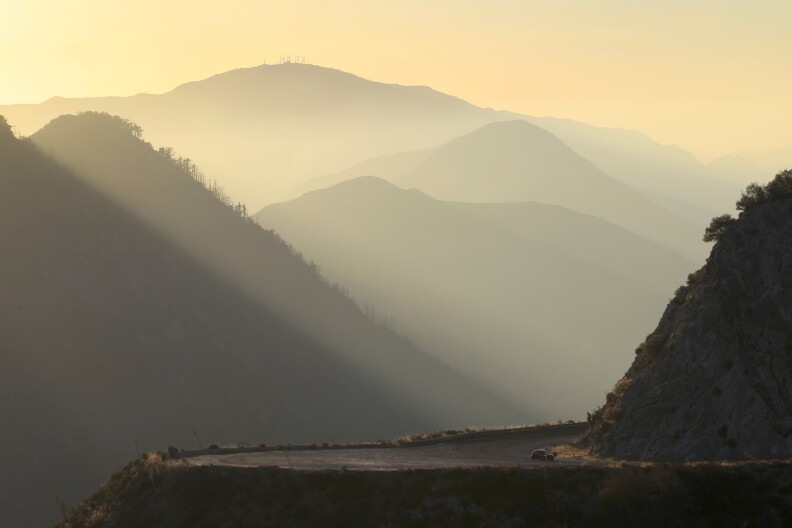 A driver rides the Angeles Crest Highway (State Route 2) in the Angeles National Forest on October 2, 2013 in the San Gabriel Mountains, northeast of Los Angeles, California. 