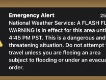 A screenshot of an emergency phone notification that says emergency alert. National weather service. A flash flood warning is in effeect for this area until 4:45 pm PST. This is a dangerious and life-threatening situation. Do not attempt to travel unless you are fleeing an area subject to flooding or under an evacuation order.