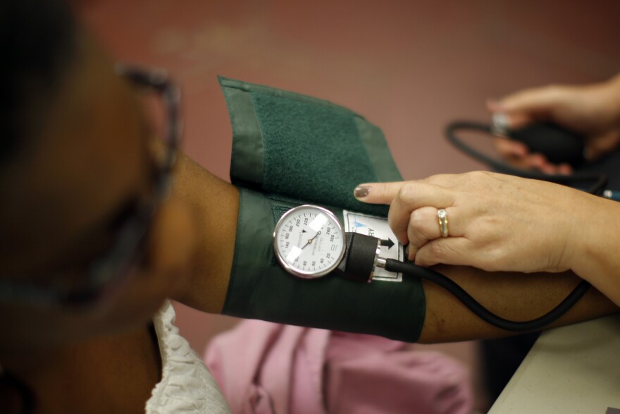 LOS ANGELES, CA - JULY 10:  Nurse Allison Miller checks the blood pressure of Keri Anderson as nurses and physicians give free basic health screenings and call attention to what they say is the ongoing healthcare emergency despite the decision of the U.S. Supreme Court to uphold the Affordable Care Act, on July 10, 2012 in Los Angeles, California. Three days of free screenings in the Los Angeles area are part of the Medicare for All tour which is making up to two dozen stops across California between June 19 and July 12. The California Nurses Association says that 30 percent of Los Angeles County adults are uninsured and 18 percent cannot afford doctor visits.   (Photo by David McNew/Getty Images)