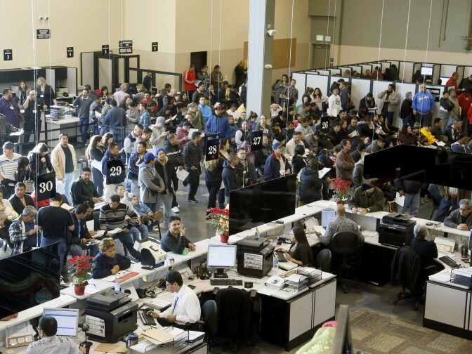 Hundreds of immigrants line up at a California Department of Motor Vehicles office to register for drivers licenses in Stanton, on Jan. 2, 2015, the first day California began issuing driver’s licenses to the nation’s largest population of immigrants in the country illegally. 