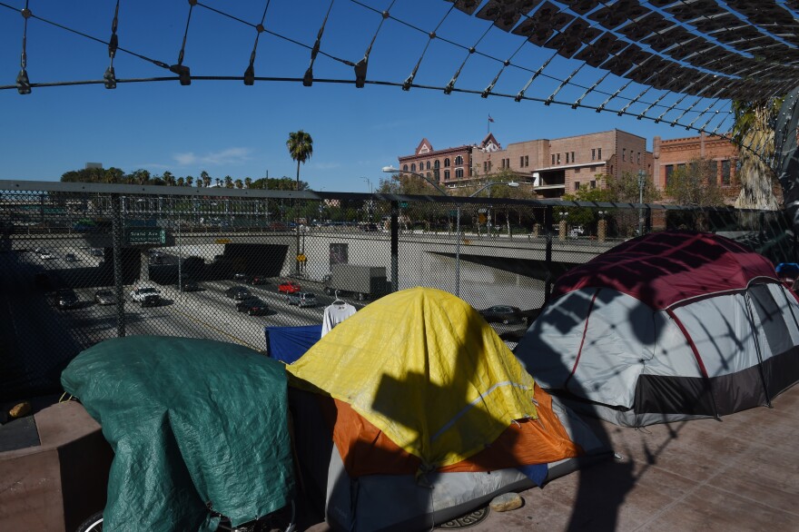 A homeless encampment on a freeway overpass near the Federal Building as a growing number displaced people spread out from downtown Los Angeles, California on December 1, 2015.     AFP PHOTO/ MARK RALSTON / AFP / MARK RALSTON        (Photo credit should read MARK RALSTON/AFP/Getty Images)