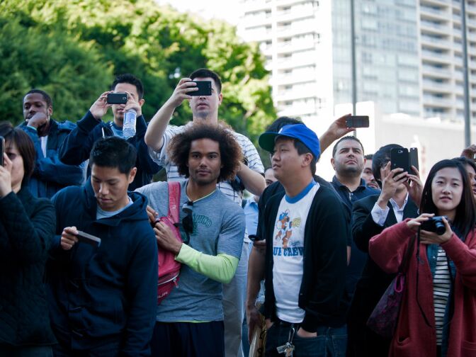 Fans take pictures as Korean pitcher Hyun-Jin Ryu emerges from the Radio Korea building on Tuesday.
