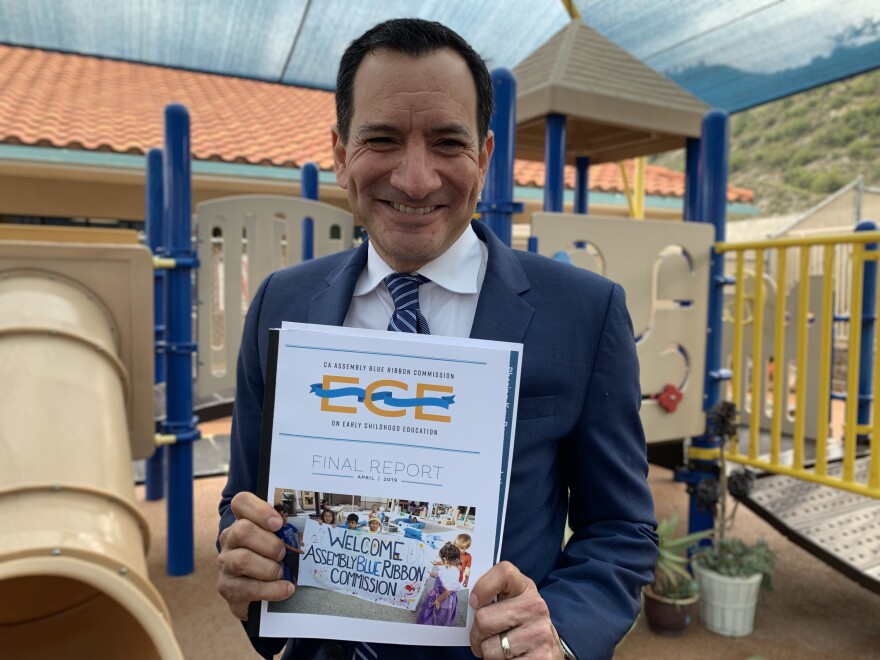 Assembly Speaker Anthony Rendon holding a copy of the final report from the Blue Ribbon Commission on early childhood education. 