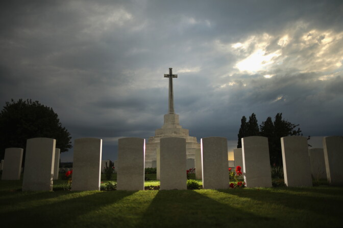 PASSCHENDAELE, BELGIUM - AUGUST 02:  The sun sets behind the Cross of Sacrifice at Tyne Cot Commonwealth War Graves Commission Memorial  on August 2, 2014 in Passchendaele, Belgium. Monday 4th August marks the 100th anniversary of Great Britain declaring war on Germany. In 1914 British Prime Minister Herbert Asquith announced at 11 pm that Britain was to enter the war after Germany had violated Belgium neutrality. The First World War or the Great War lasted until 11 November 1918 and is recognised as one of the deadliest historical conflicts with millions of causalities. A series of events commemorating the 100th anniversary are taking place throughout the day.  (Photo by Christopher Furlong/Getty Images)
