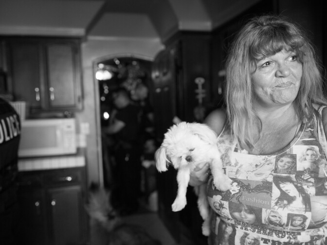A woman, who took in a relative recently released from jail, looks out of her home in Corona, Calif. on June 20th, 2013.