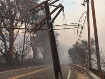 Highway 150 was impassable about 1/4 mile south of Thomas Aquinas College due to burned power poles on Wednesday, Dec. 6, 2017, after the Thomas Fire swept through the area.