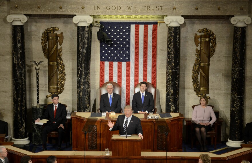 U.S. President Donald J. Trump (C) makes remarks during his address to a joint session of Congress, as Vice President Mike Pence (L) and House Speaker Paul Ryan listen, at the U.S. Capitol, in Washington, DC, February 28, 2017. Trump, in his first address to Congress, laid out his agenda on issues like immigration, the economy, foreign affairs and health care.                 / AFP / Mike Theiler        (Photo credit should read MIKE THEILER/AFP/Getty Images)