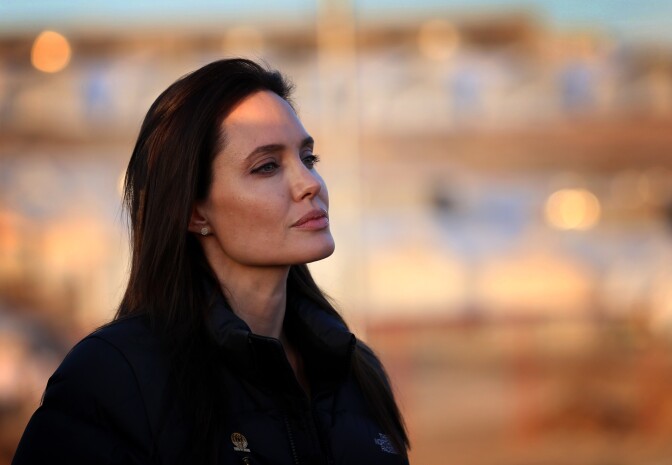 US actress and UNHCR ambassador Angelina Jolie stands during a visit to a camp for displaced Iraqis in Khanke, a few kilometres (miles) from the Turkish border in Iraq's Dohuk province, on January 25, 2015. Run by authorities from the three-province autonomous Kurdish region of north Iraq with the help of the United Nations refugee agency, the UNHCR, Khanke aims to house 18,000 people, said the agency's Liena Veide. AFP PHOTO/SAFIN HAMED        (Photo credit should read SAFIN HAMED/AFP/Getty Images)